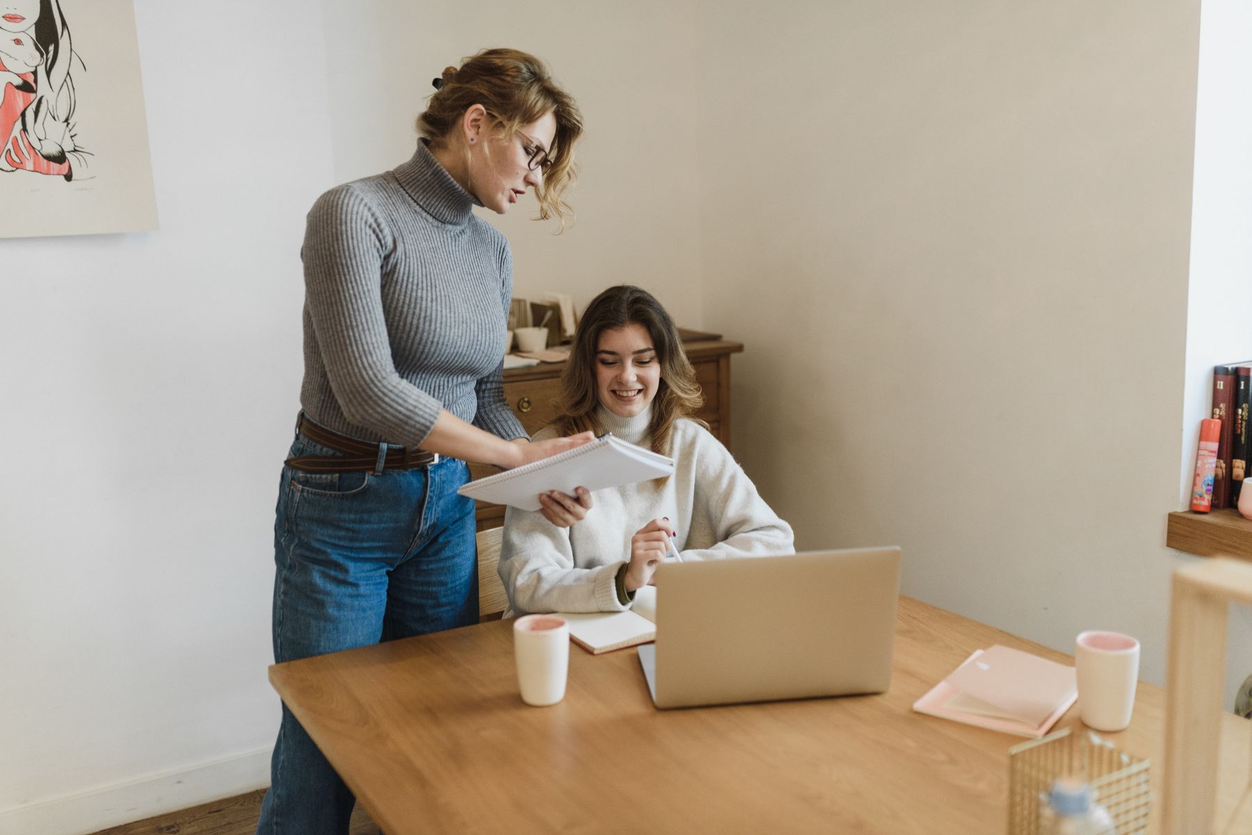 Two professionals collaborating at a laptop